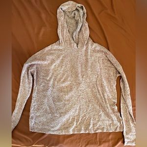 Hooded long sleeve shirt with an open style back.